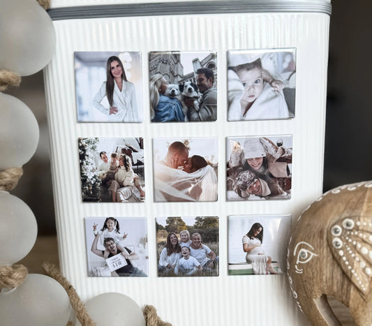 Nine square custom magnets displayed on a white magnetic container, styled with a wooden elephant with white markings and glass baubles.
